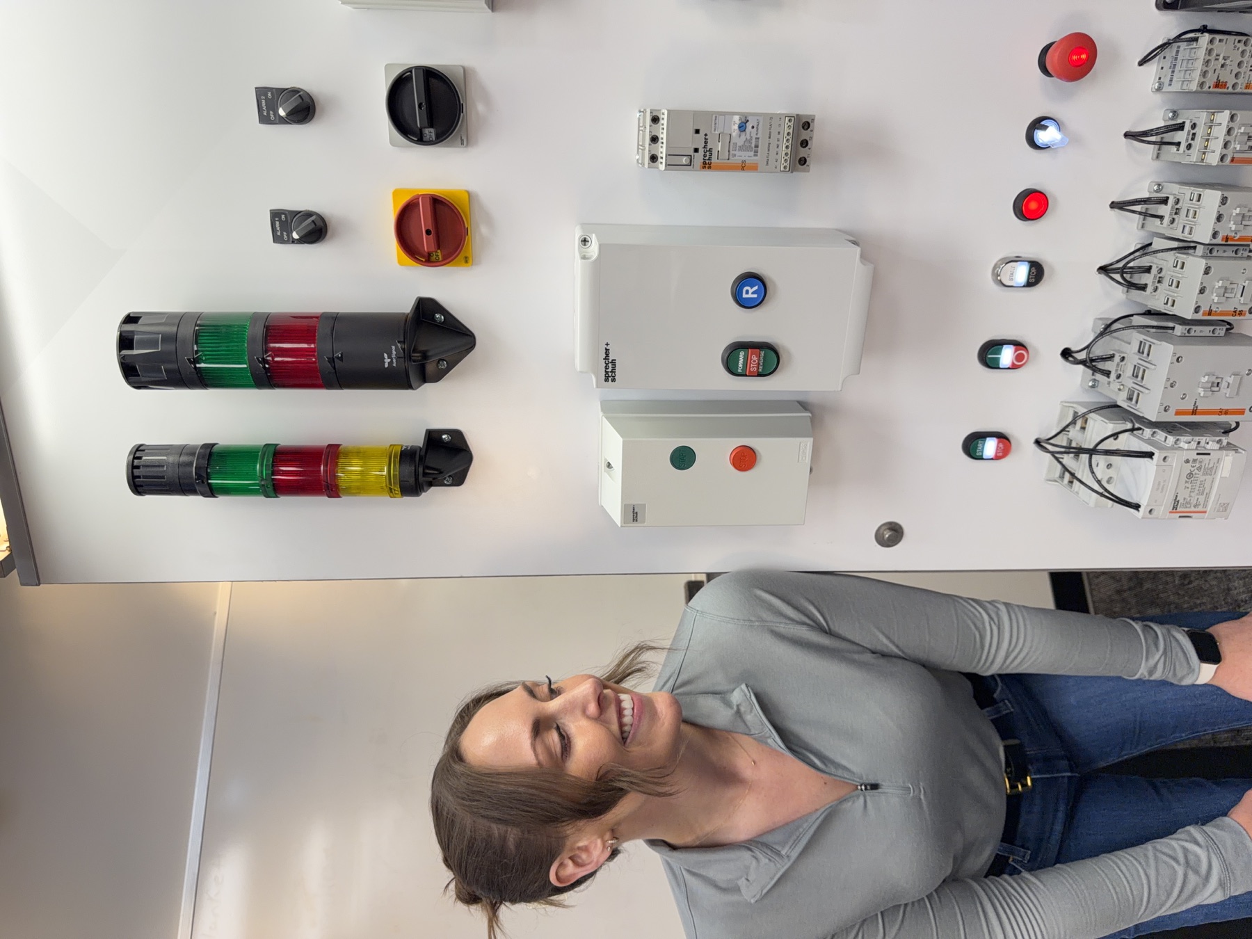Jordan Yates beside a working Sprecher + Schuh industrial control display